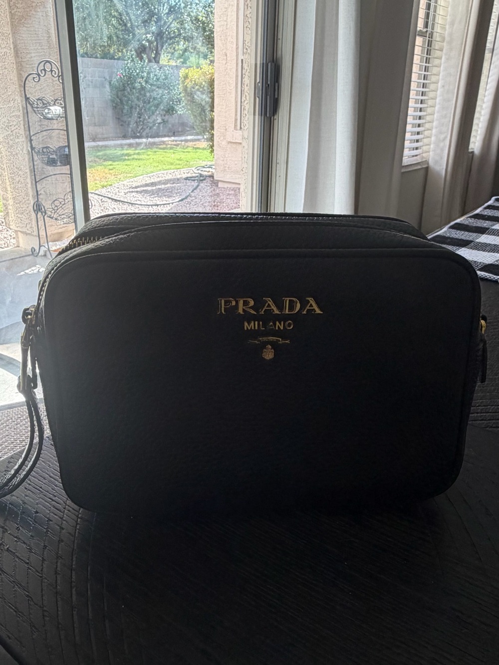 Prada Black Leather Camera bag with Two Zipper compartments.